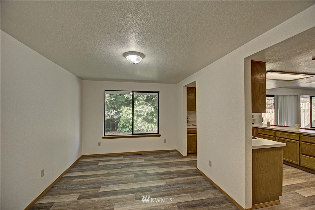 1820 Diamond Loop Southeast Lacey, WA 98503 - Photo 4 of 17 a view of a room with window and wooden floor