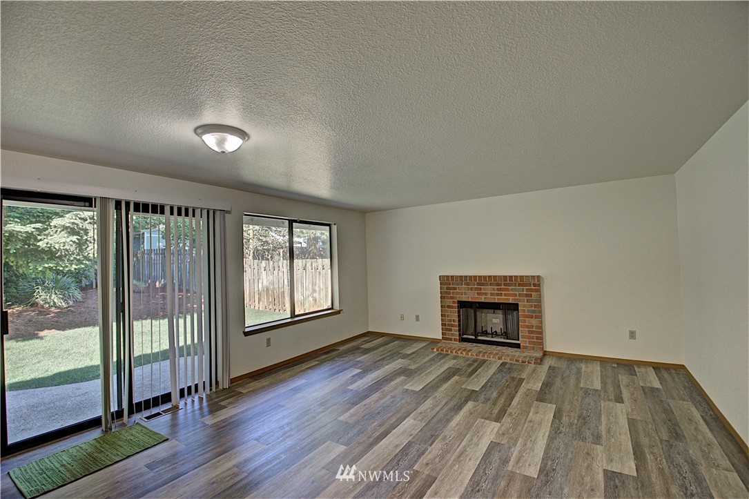 1820 Diamond Loop Southeast Lacey, WA 98503 - Photo 6 of 17 wooden floor in an empty room with a window