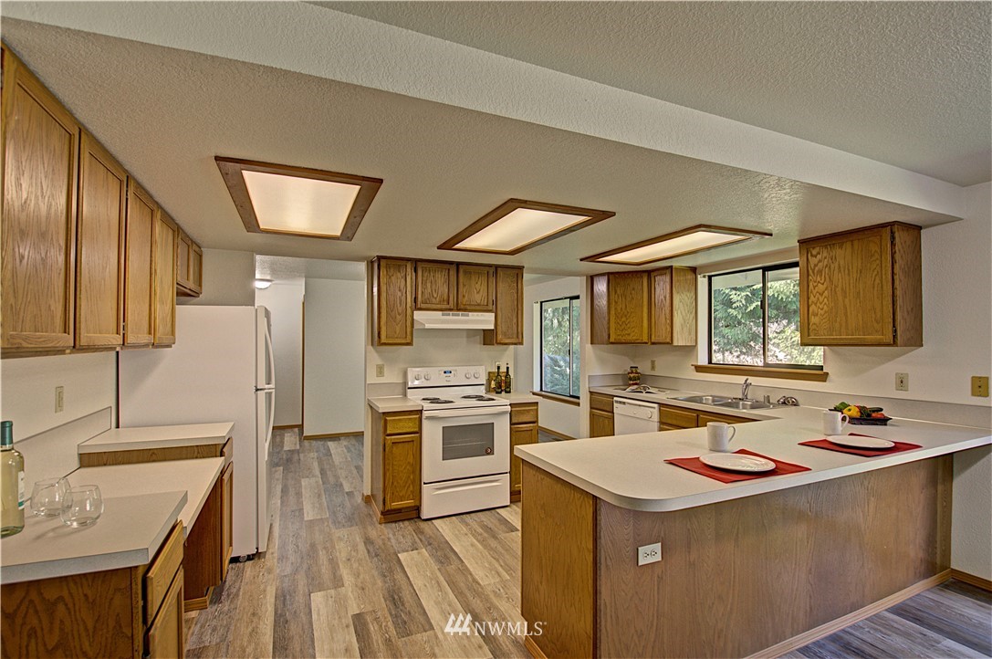 1820 Diamond Loop Southeast Lacey, WA 98503 - Photo 7 of 17 a kitchen that has a sink and a stove top oven