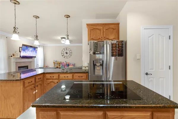a kitchen with stainless steel appliances granite countertop a refrigerator and a stove