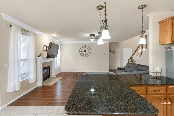 a view of a hallway view with fireplace and wooden floor