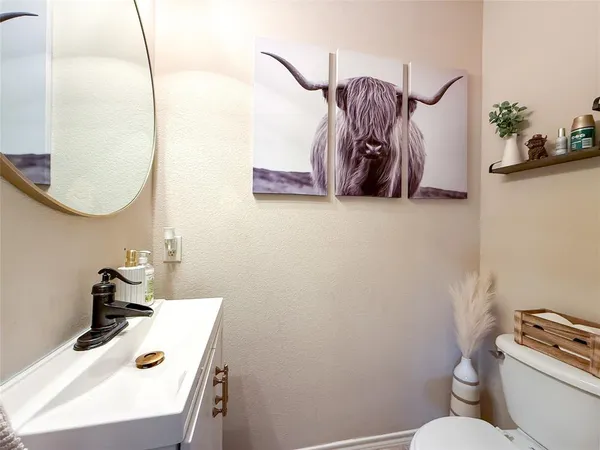 a bathroom with a sink a toilet and a mirror