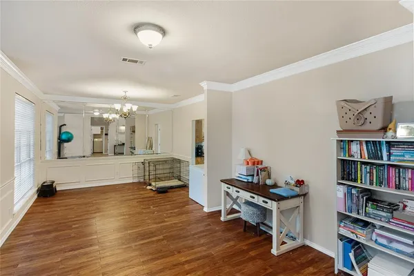a living room with furniture and a book shelf