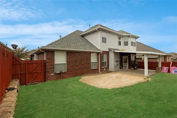 a view of a house with a yard and sitting area