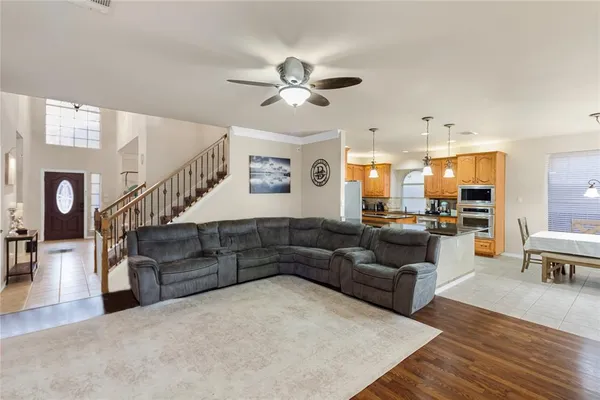 a living room with furniture and wooden floor