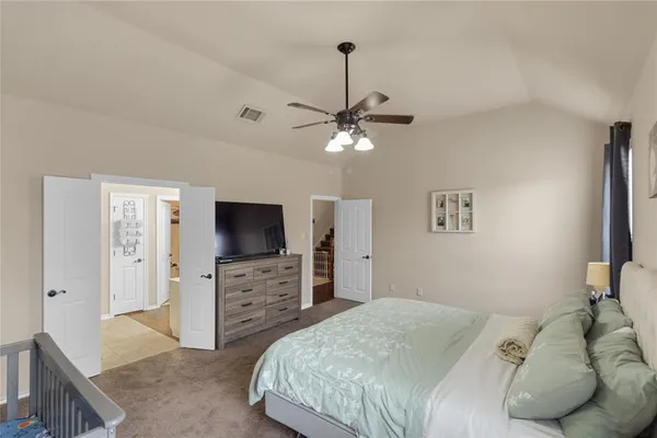 a bedroom with a bed and a flat screen tv