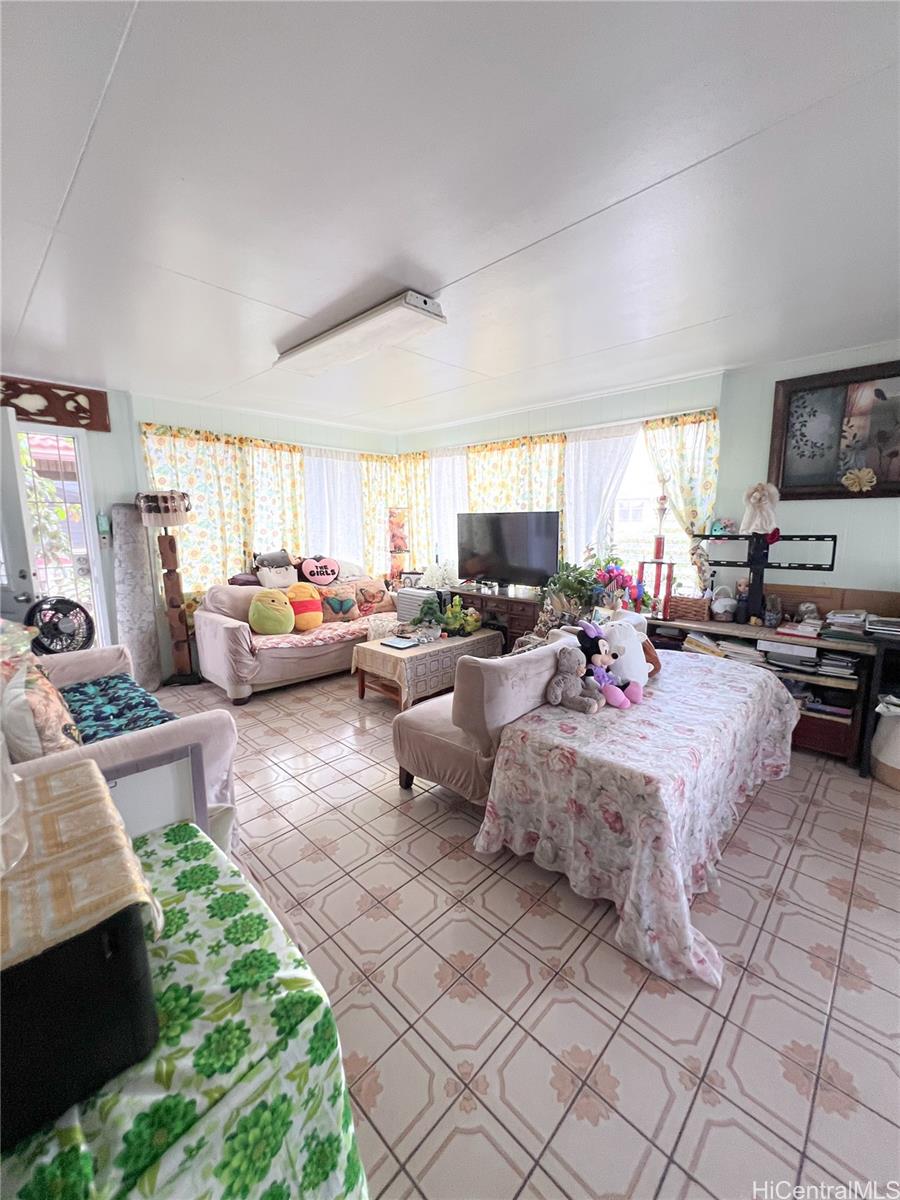 1815 Eluwene Street Honolulu, HI 96819 - Photo 3 of 11 a living room with furniture fireplace and a window