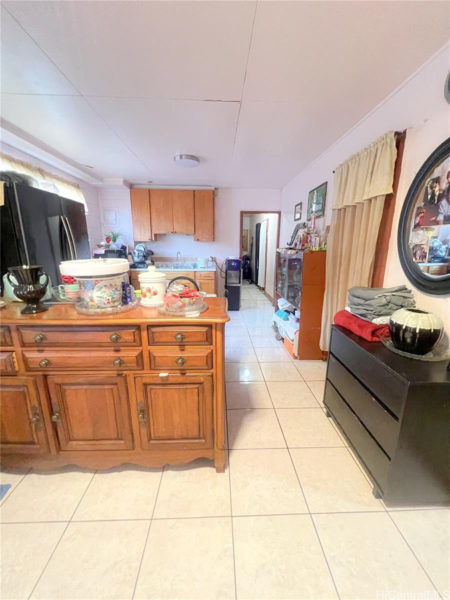 1815 Eluwene Street Honolulu, HI 96819 - Photo 6 of 11 a kitchen with stainless steel appliances kitchen island granite countertop a sink and cabinets