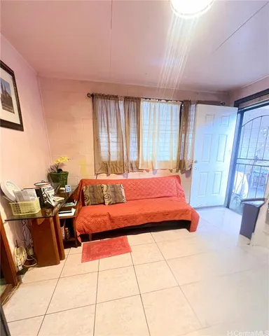 a bedroom with furniture and large windows