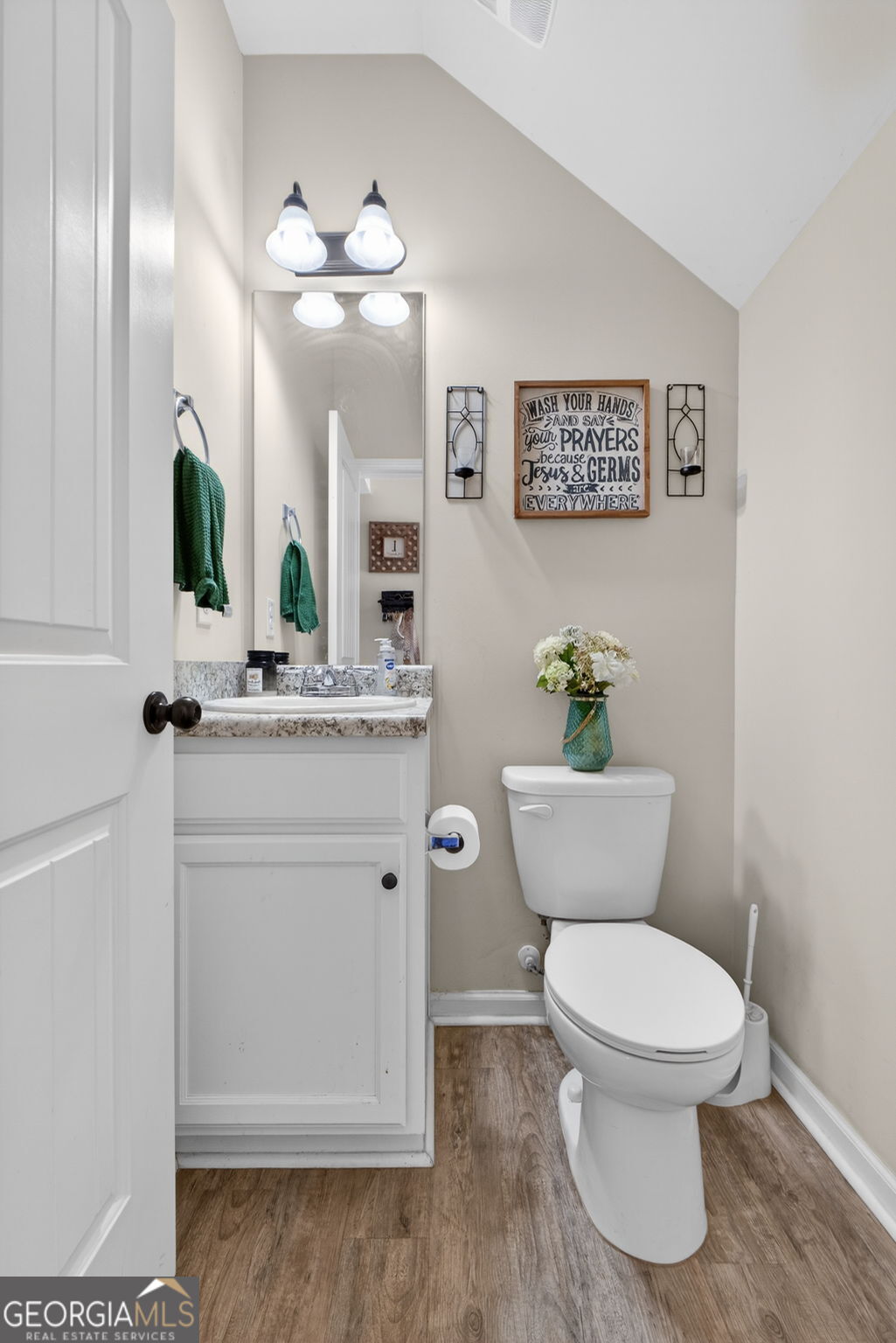 482 Louise Way Locust Grove, GA 30248 - Photo 12 of 29 a bathroom with a toilet a sink and mirror