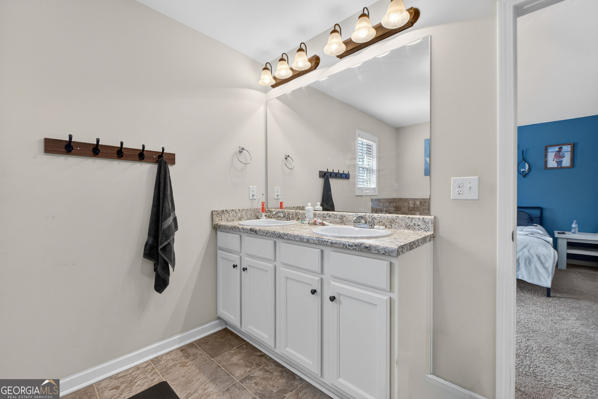 482 Louise Way Locust Grove, GA 30248 - Photo 15 of 29 a bathroom with a sink vanity and mirror