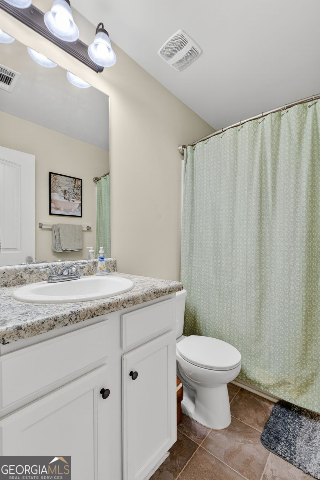 482 Louise Way Locust Grove, GA 30248 - Photo 20 of 29 a bathroom with a granite countertop sink toilet and a mirror