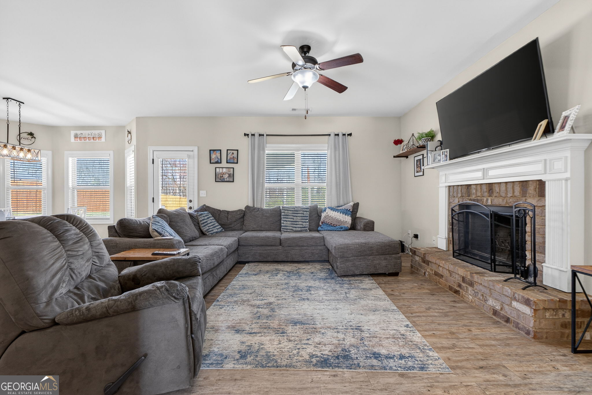 482 Louise Way Locust Grove, GA 30248 - Photo 5 of 29 a living room with furniture a fireplace and a flat screen tv