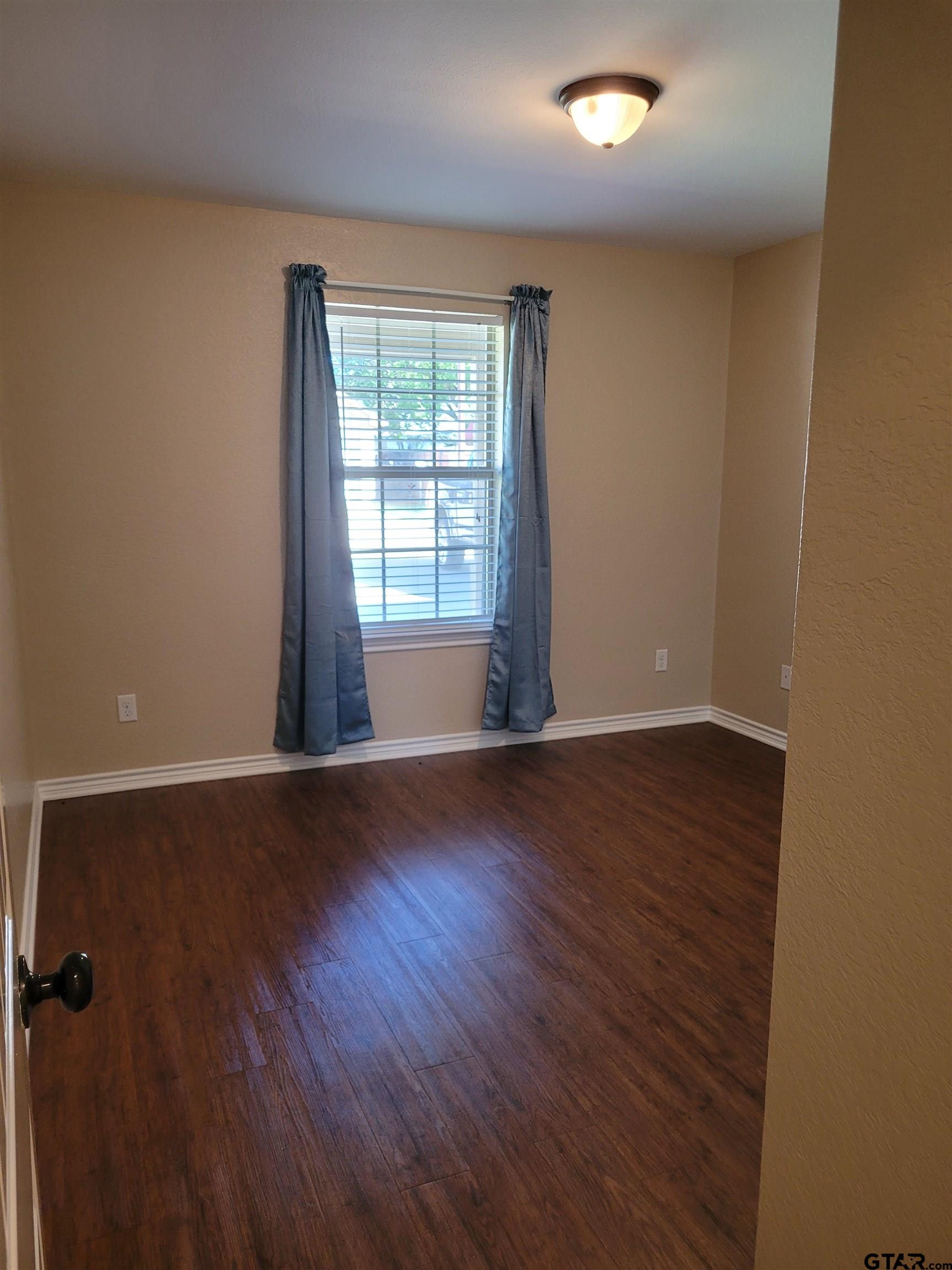 19054 County Road 1202 Flint, TX 75762 - Photo 16 of 19 an empty room with wooden floor and windows