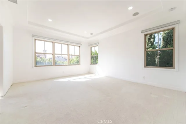 an empty room with windows and closet