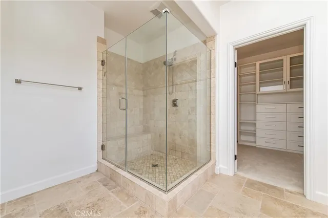 a bathroom that has a glass shower door
