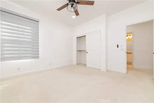 a view of empty room with ceiling fan