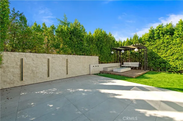 a backyard of a house with table and chairs