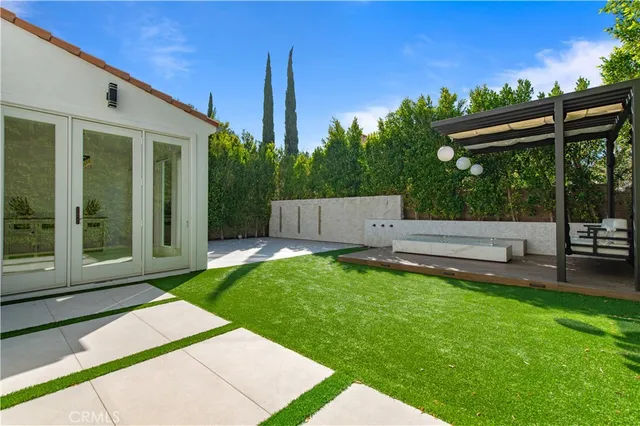 a backyard of a house with table and chairs