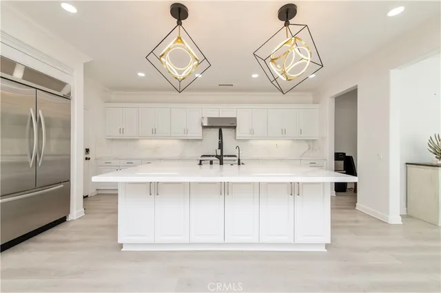 a view of a kitchen with a sink stainless steel appliances and cabinets