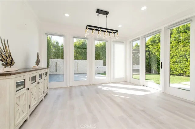a view of a room with wooden floor and windows