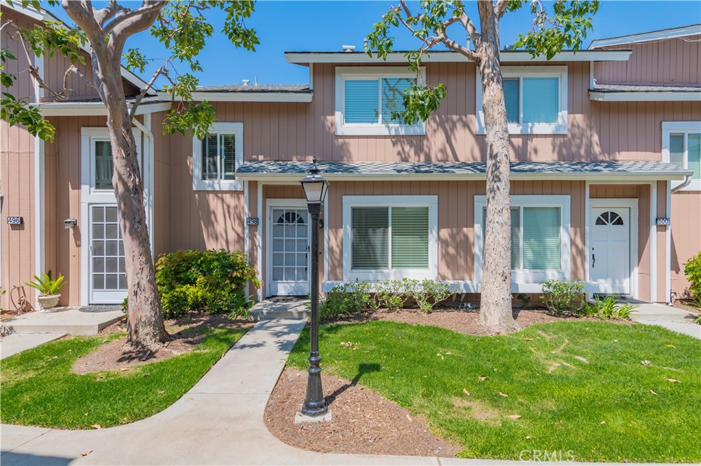 a view of a house with a yard and plants