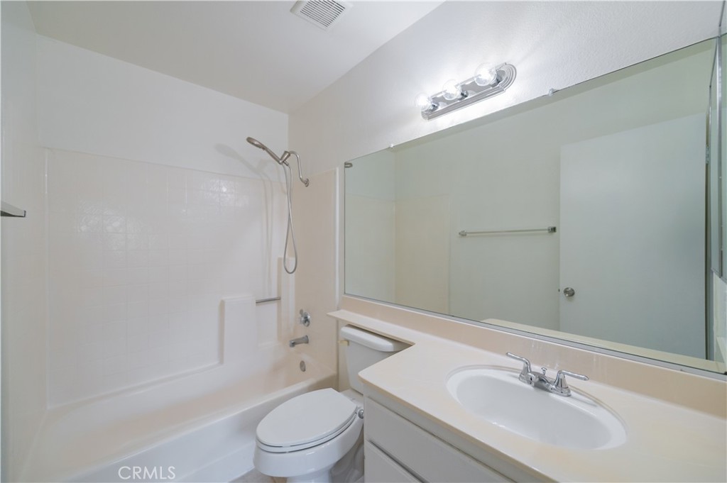 498 Monroe, Unit 15 Irvine, CA 92620 - Photo 13 of 26 a bathroom with a sink a toilet and shower
