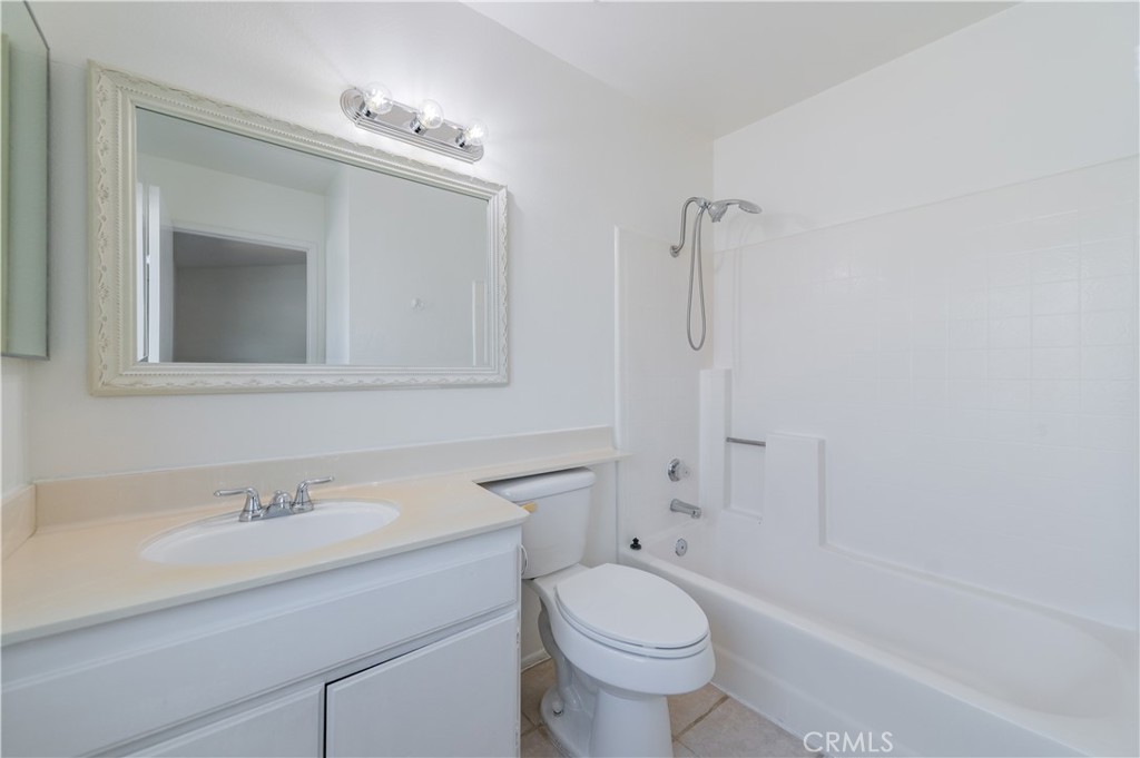 498 Monroe, Unit 15 Irvine, CA 92620 - Photo 15 of 26 a bathroom with a sink a toilet and shower
