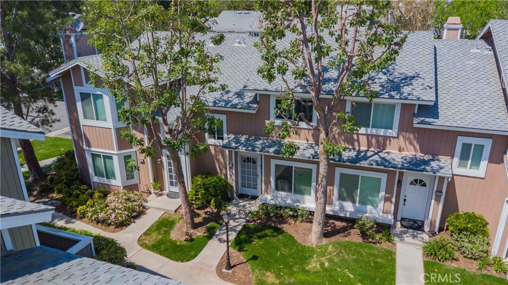498 Monroe, Unit 15 Irvine, CA 92620 - Photo 22 of 26 front view of house with a yard and potted plants