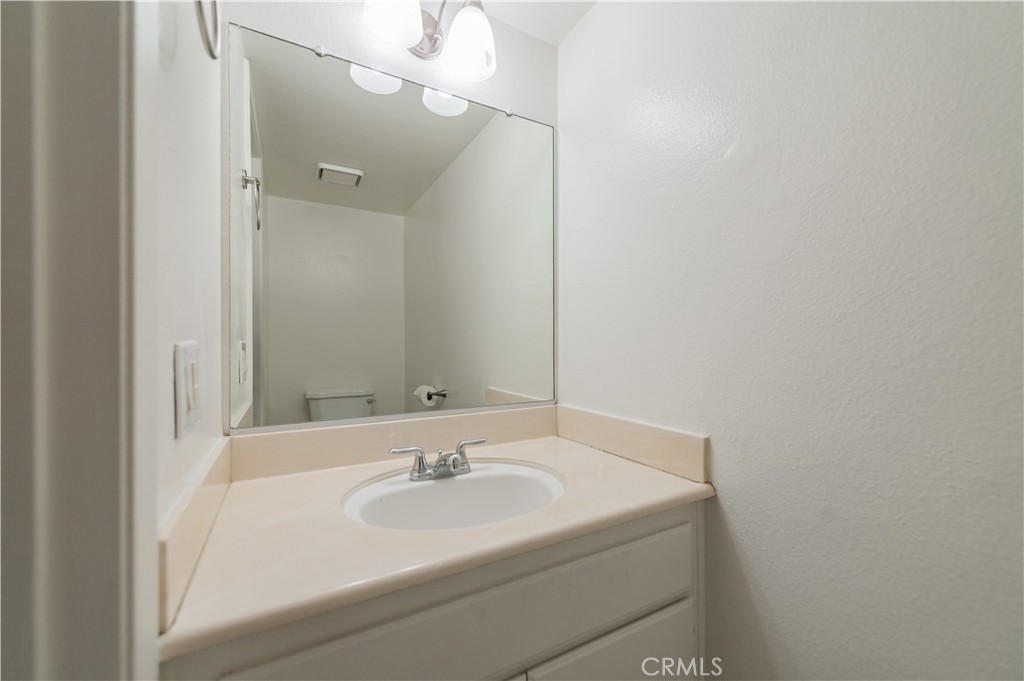 498 Monroe, Unit 15 Irvine, CA 92620 - Photo 9 of 26 a bathroom with a sink and a mirror