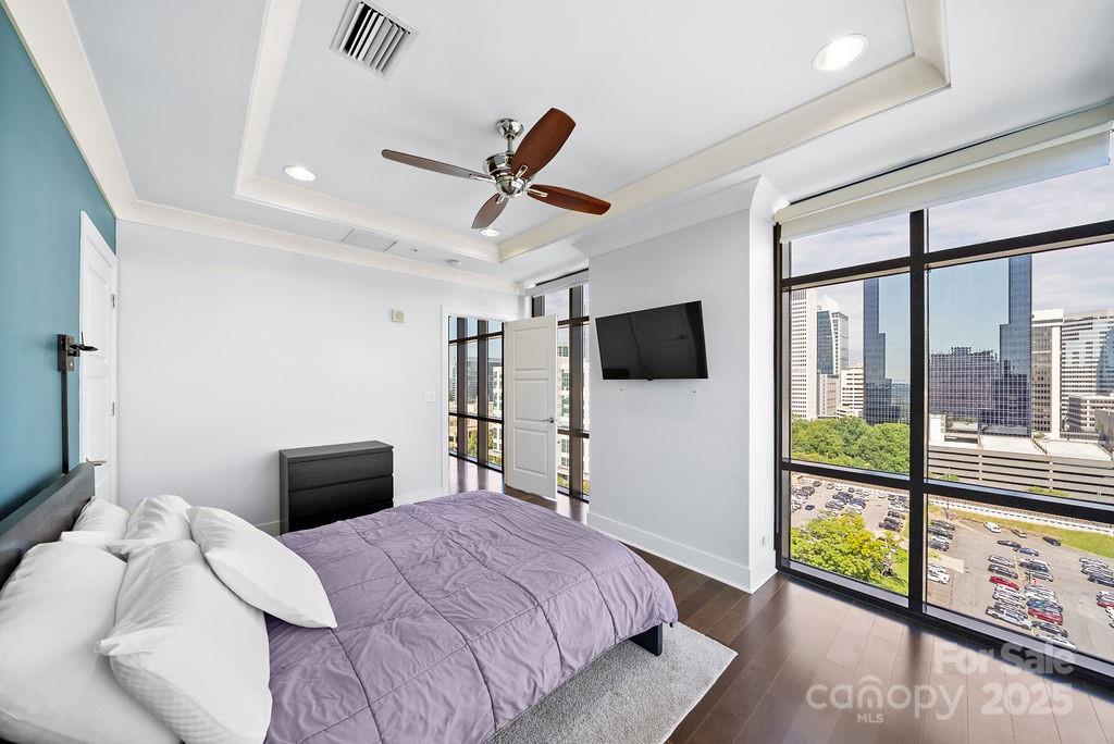 222 South Caldwell Street, Unit 1509 Charlotte, NC 28202 - Photo 11 of 27 a bedroom with a bed and a flat screen tv