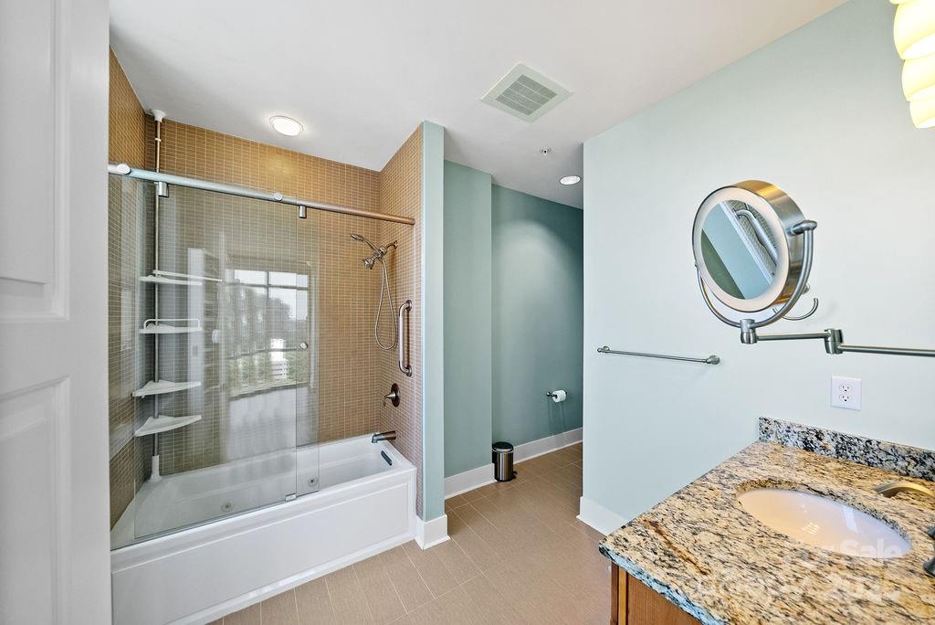 222 South Caldwell Street, Unit 1509 Charlotte, NC 28202 - Photo 13 of 27 a bathroom with a sink and a mirror