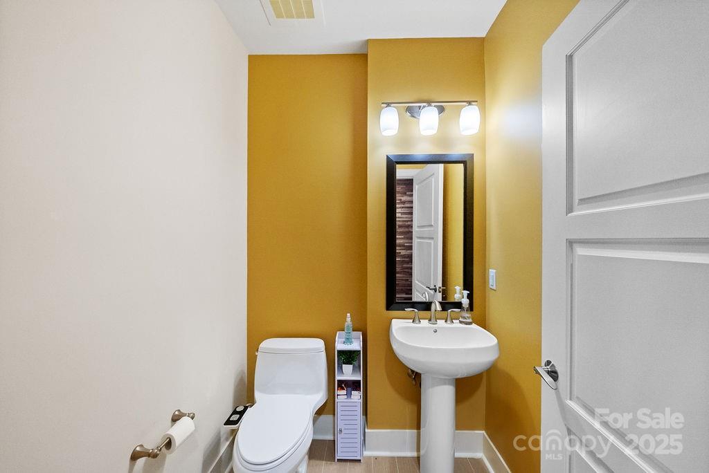 222 South Caldwell Street, Unit 1509 Charlotte, NC 28202 - Photo 16 of 27 a bathroom with a sink and a mirror