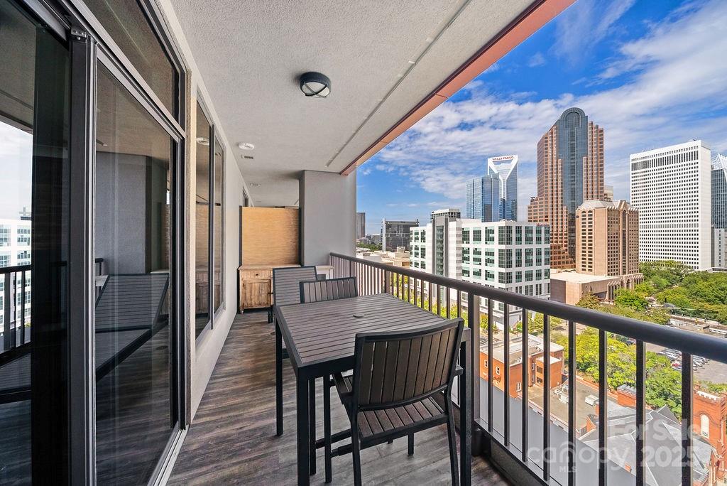 222 South Caldwell Street, Unit 1509 Charlotte, NC 28202 - Photo 17 of 27 a view of a balcony dining table and chairs