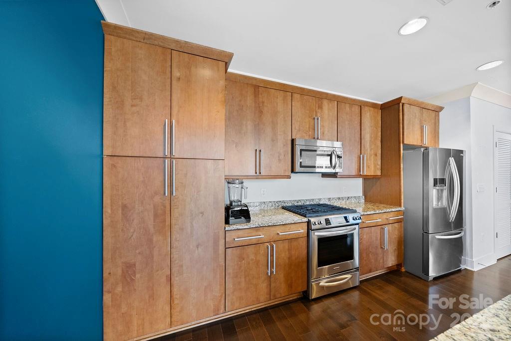 222 South Caldwell Street, Unit 1509 Charlotte, NC 28202 - Photo 7 of 27 a kitchen with a refrigerator stove and microwave