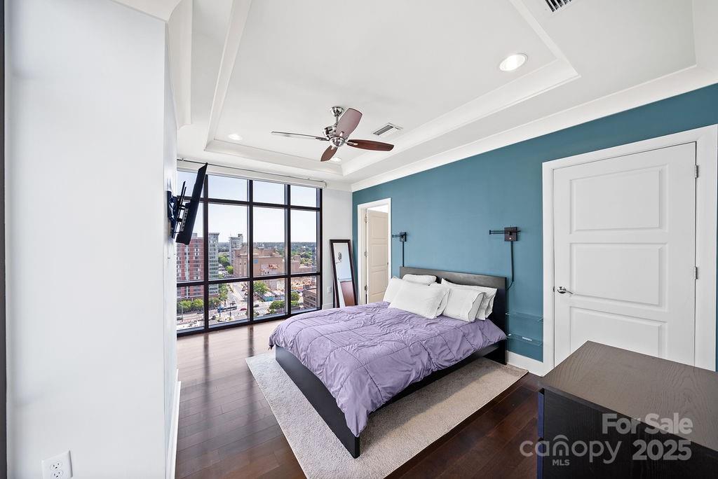 222 South Caldwell Street, Unit 1509 Charlotte, NC 28202 - Photo 10 of 27 a bedroom with a large bed and a window
