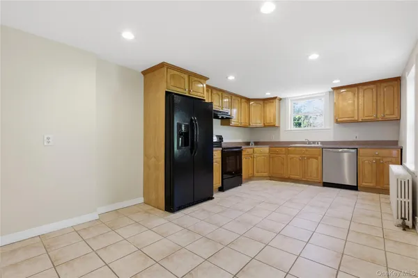 a kitchen with stainless steel appliances granite countertop a refrigerator and a sink