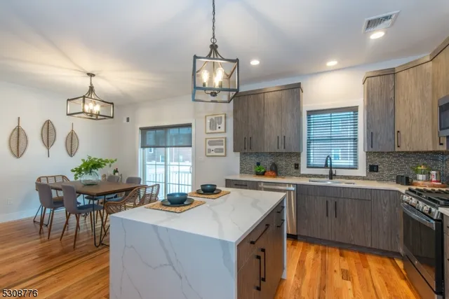 a kitchen with a sink stove and cabinets