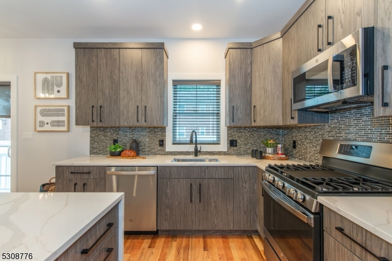 360 Orange Road, Unit 1 Montclair, NJ 07042 - Photo 13 of 41 a kitchen with stainless steel appliances granite countertop a stove a sink and a microwave