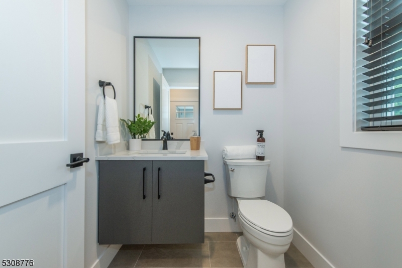 360 Orange Road, Unit 1 Montclair, NJ 07042 - Photo 18 of 41 a bathroom with a granite countertop toilet sink and mirror