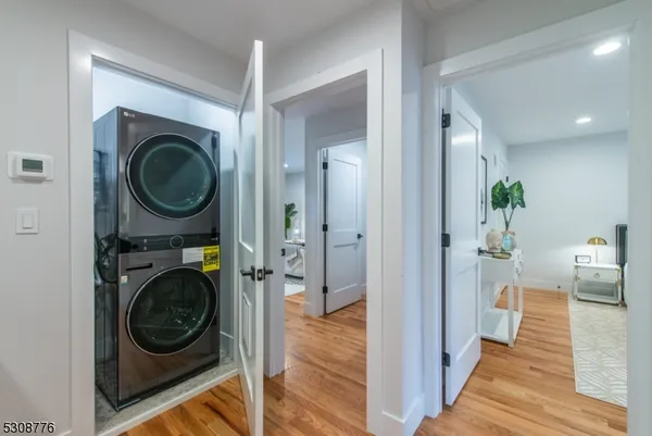 a view of a hallway with washer and dryer