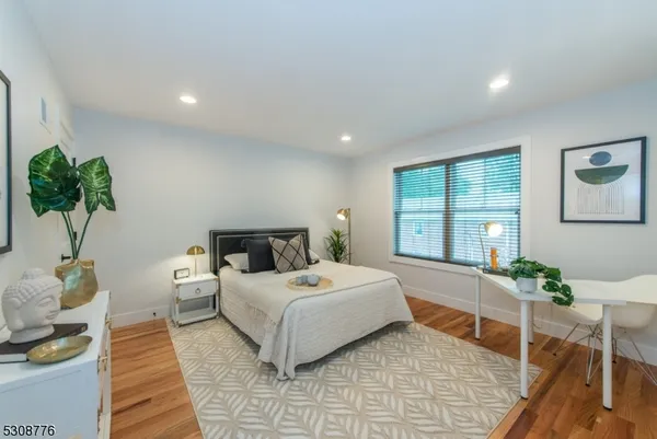 a bedroom with a bed table and a window