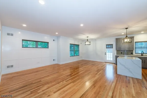 a view of kitchen and hall with wooden floor