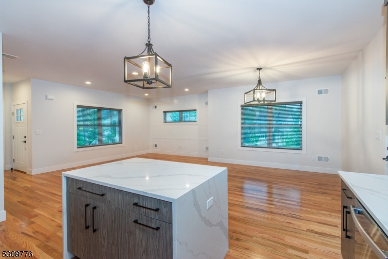 360 Orange Road, Unit 1 Montclair, NJ 07042 - Photo 35 of 41 a view of an empty room with window wooden floor and chandelier