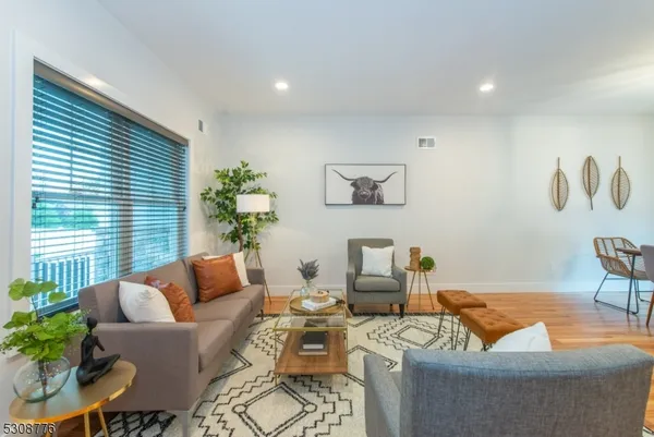 a living room with furniture and a potted plant