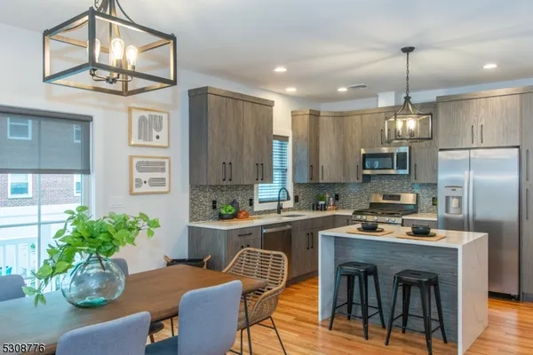 a kitchen with cabinets and stainless steel appliances