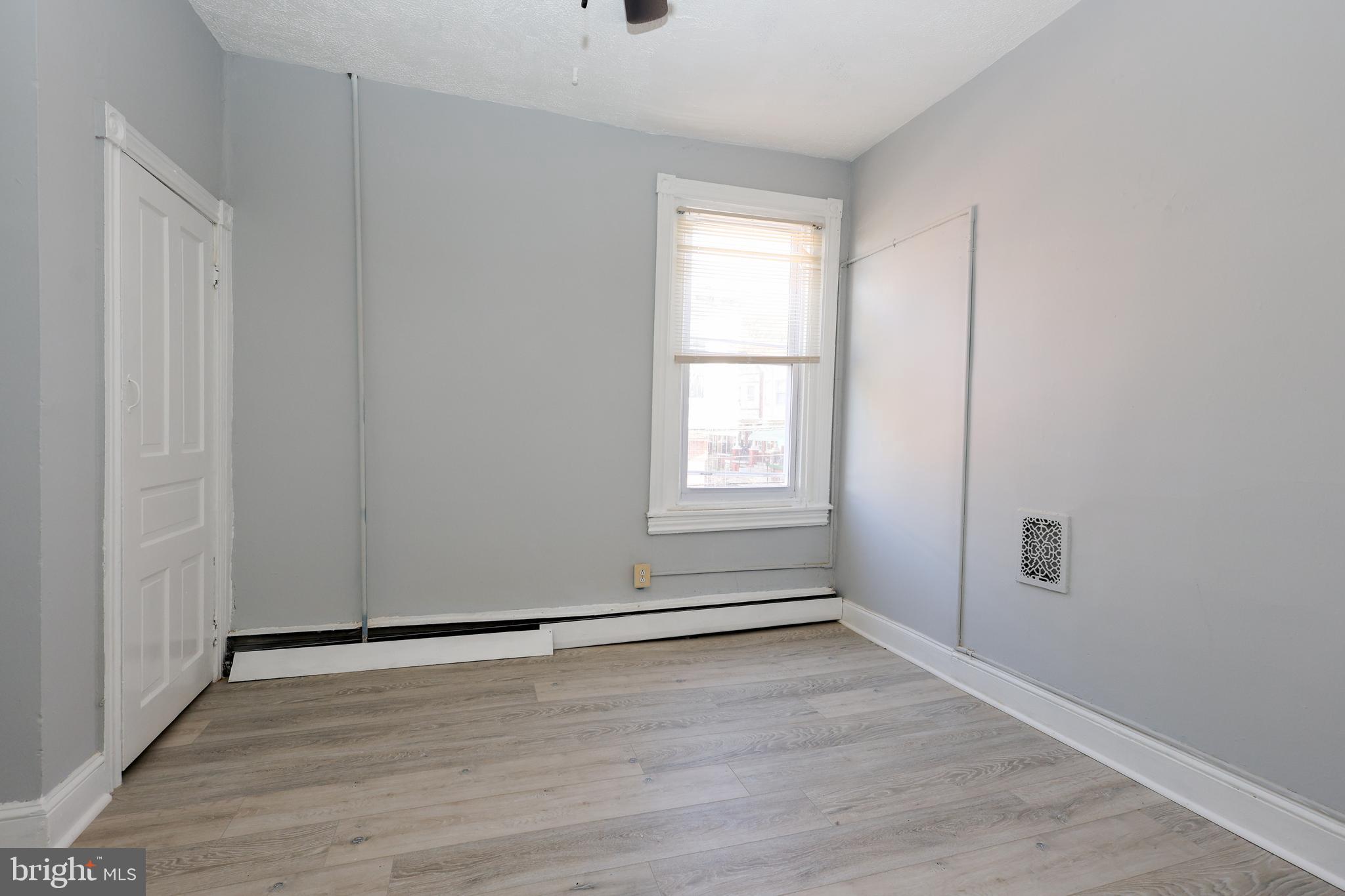 76 West Sharpnack Street Philadelphia, PA 19119 - Photo 5 of 14 an empty room with wooden floor and windows