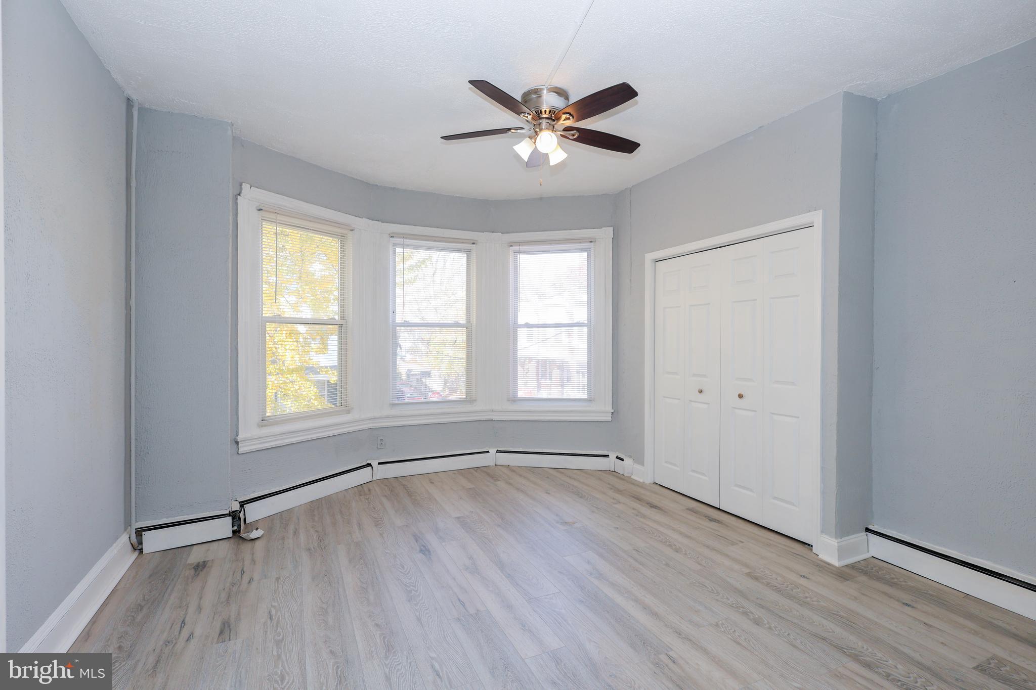 76 West Sharpnack Street Philadelphia, PA 19119 - Photo 8 of 14 a view of an empty room with a window and wooden floor