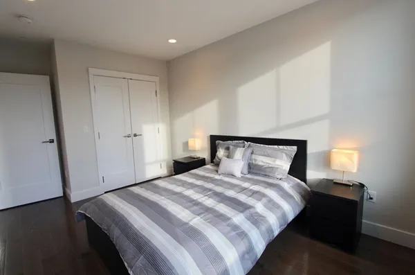 a bedroom with a bed and a night stand