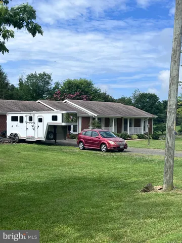 a front view of house with yard and trees